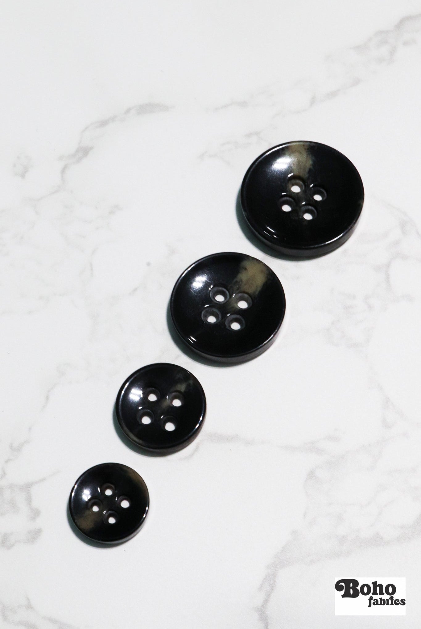 Black Tortoiseshell Round Plastic Four Hole Buttons. Available in 15mm (24L), 18mm (28L), 20mm (32L), and 28mm (44L) - Boho Fabrics - Buttons & Snaps