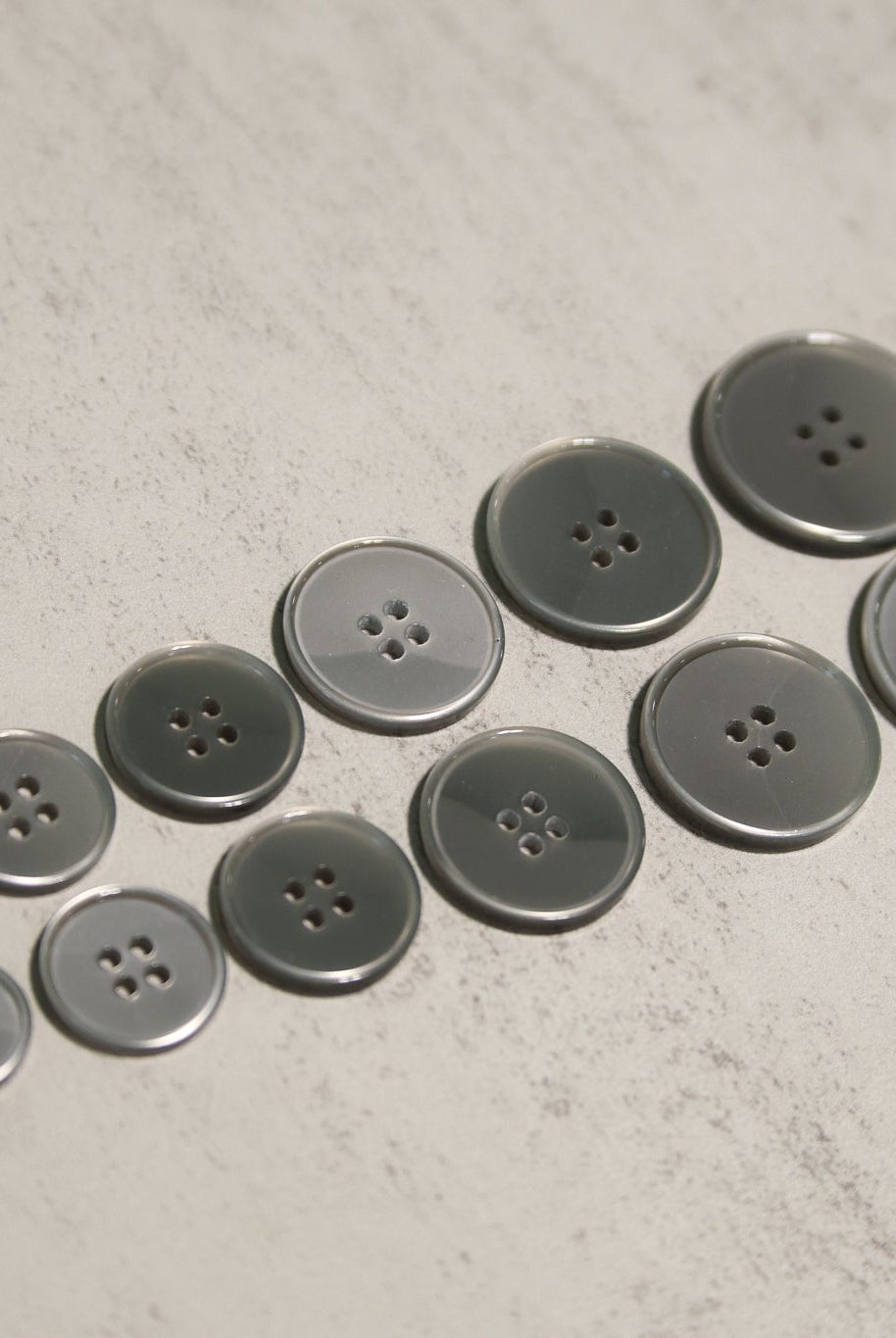 Glossy Silver/Gray Four Hole Plastic Buttons. 24L (15mm/ 5/8"), 28L, (18mm/ 11/16"), 32L (20mm / 13/16"), 36L (23mm, 7/8"), 40L (25mm/ 1"), 44L (28mm/ 1 1/8") - Boho Fabrics - Buttons & Snaps