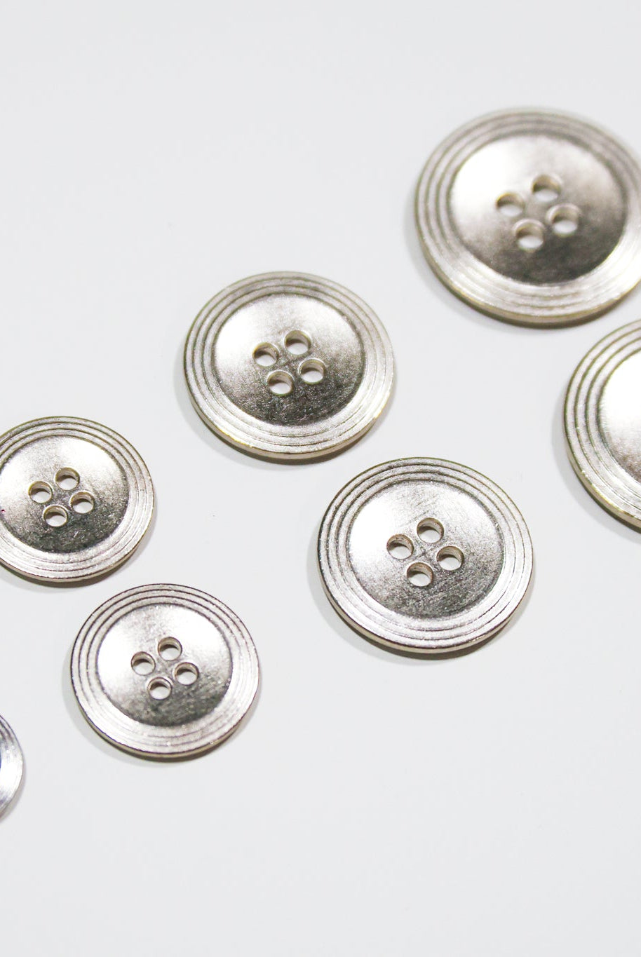 Nickel 4-Hole Buttons. 22L (14mm / 9/16"), 28L (18mm / 11/16"), 34L (21mm / 7/8"), 40L (25mm / 1") - Boho Fabrics - Buttons & Snaps