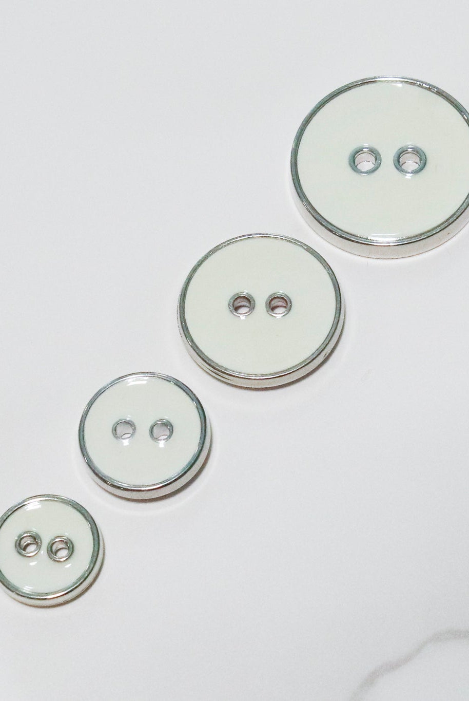 Off White Silver Rimmed Two - hole Buttons. Available in 12.5mm (20L), 15mm (24L), 19mm (30L), 23mm (36L) - Boho Fabrics - Buttons & Snaps