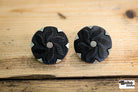 Black Floral Pinwheel on Silver Plastic Shank Button. Available in 17.8mm (28L), 21.6mm (34L) and 25.4mm (40L) - Boho Fabrics - Buttons & Snaps