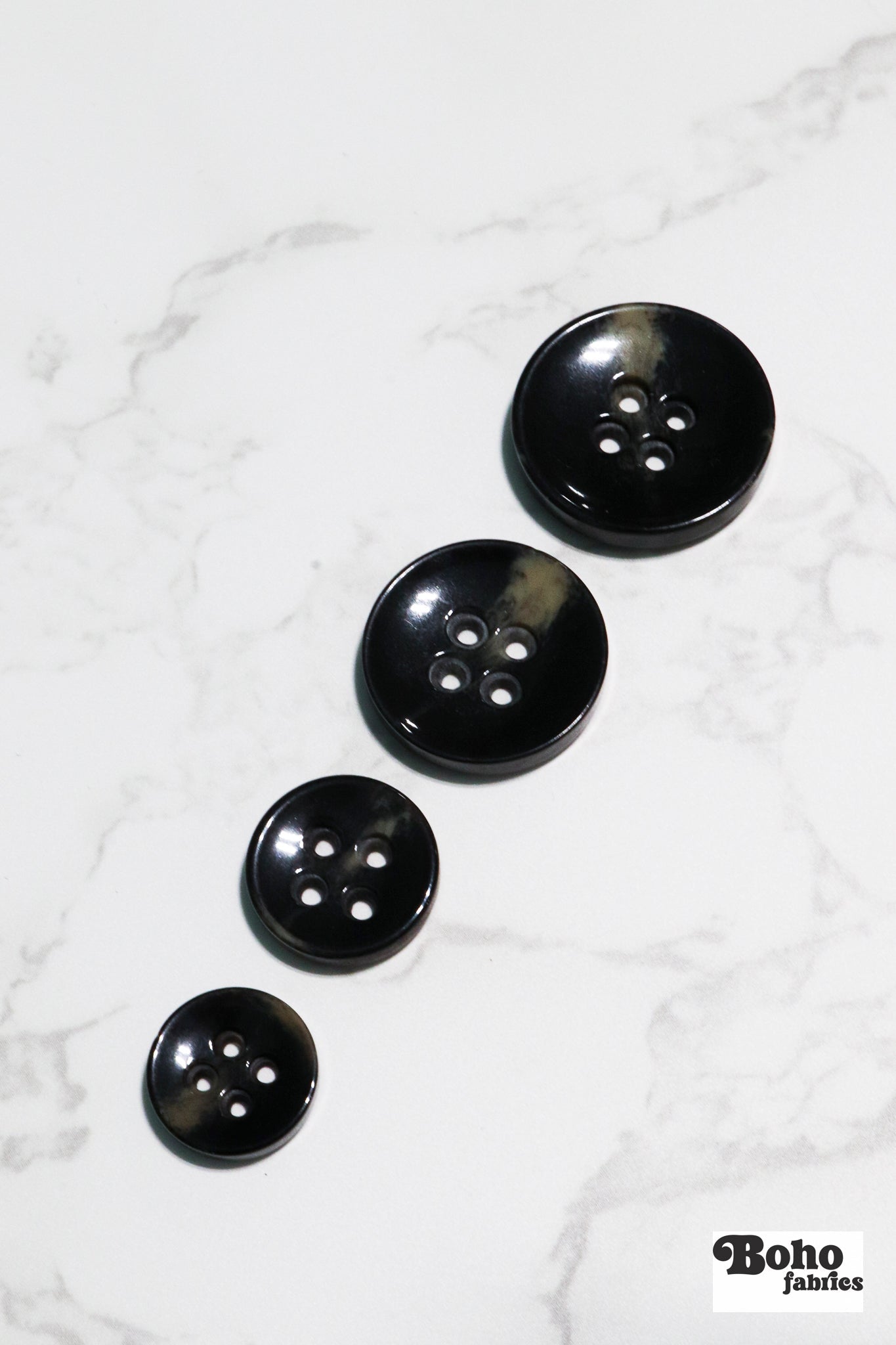 Black Tortoiseshell Round Plastic Four Hole Buttons. Available in 15mm (24L), 18mm (28L), 20mm (32L), and 28mm (44L) - Boho Fabrics - Buttons & Snaps