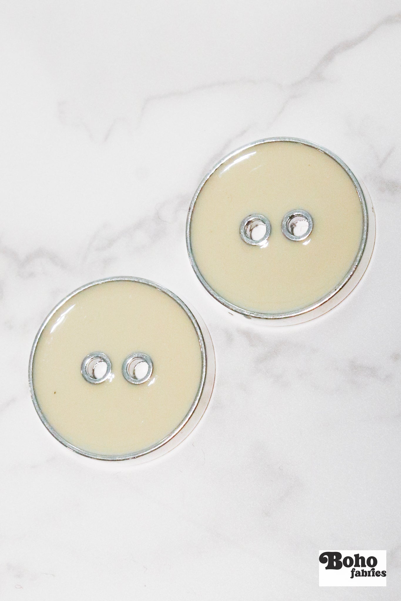 Eggshell Silver Rimmed Two - hole Buttons. Available in 15mm (24L), 19mm (30L), 23mm (36L), and 25mm (40L) - Boho Fabrics - Buttons & Snaps