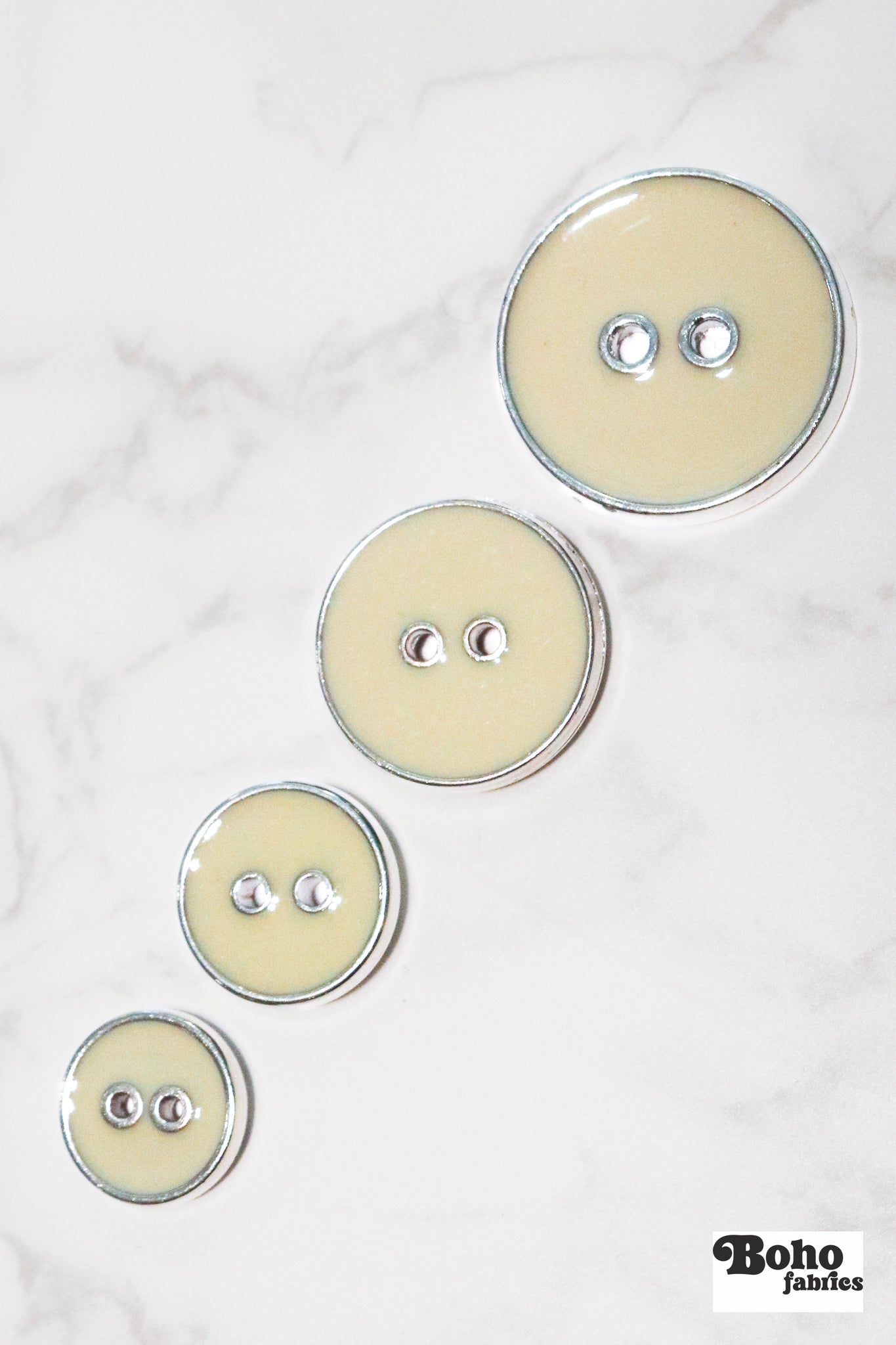 Eggshell Silver Rimmed Two - hole Buttons. Available in 15mm (24L), 19mm (30L), 23mm (36L), and 25mm (40L) - Boho Fabrics - Buttons & Snaps