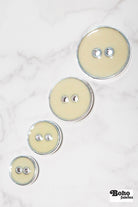 Eggshell Silver Rimmed Two - hole Buttons. Available in 15mm (24L), 19mm (30L), 23mm (36L), and 25mm (40L) - Boho Fabrics - Buttons & Snaps