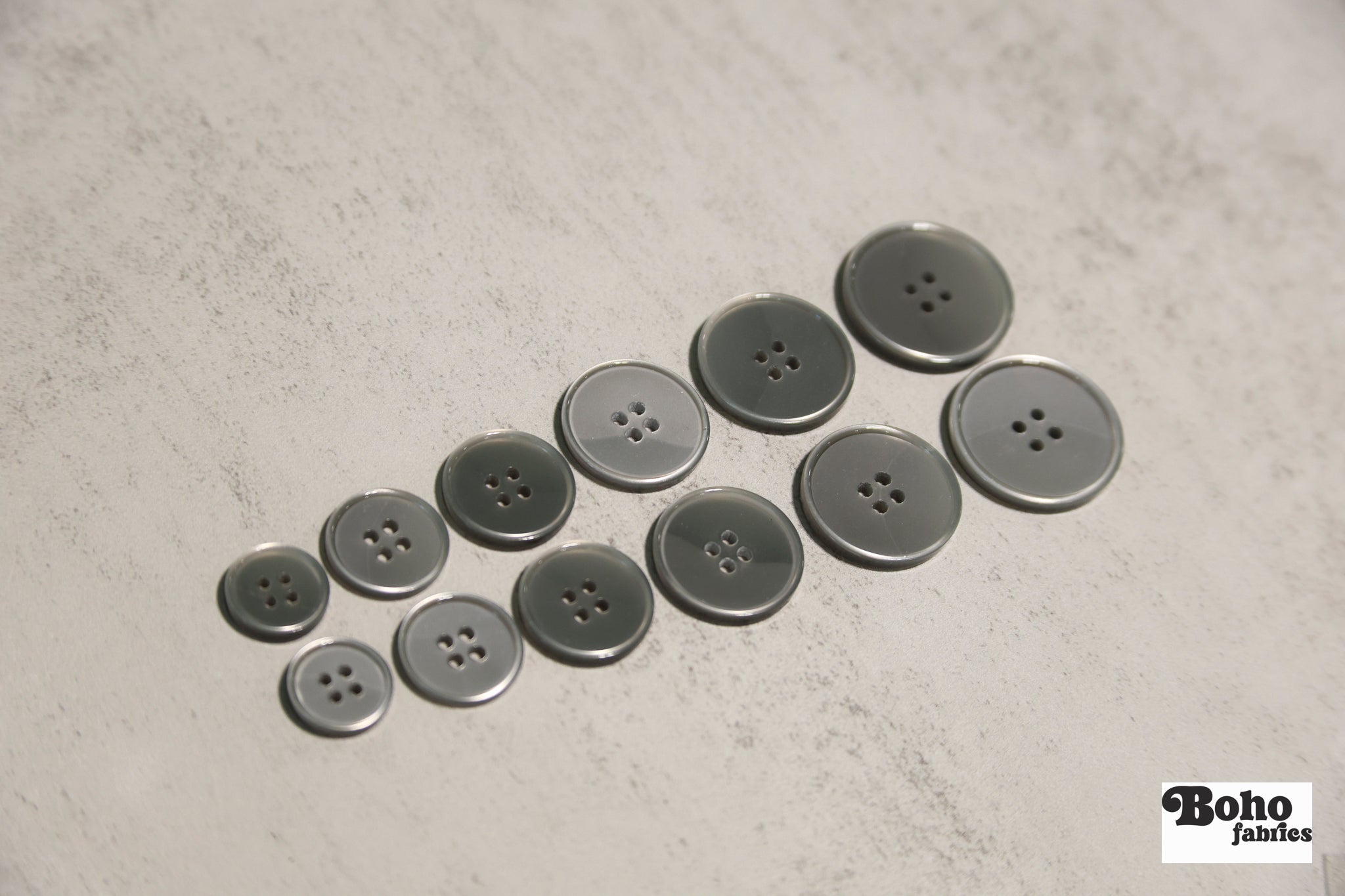 Glossy Silver/Gray Four Hole Plastic Buttons. 24L (15mm/ 5/8"), 28L, (18mm/ 11/16"), 32L (20mm / 13/16"), 36L (23mm, 7/8"), 40L (25mm/ 1"), 44L (28mm/ 1 1/8") - Boho Fabrics - Buttons & Snaps