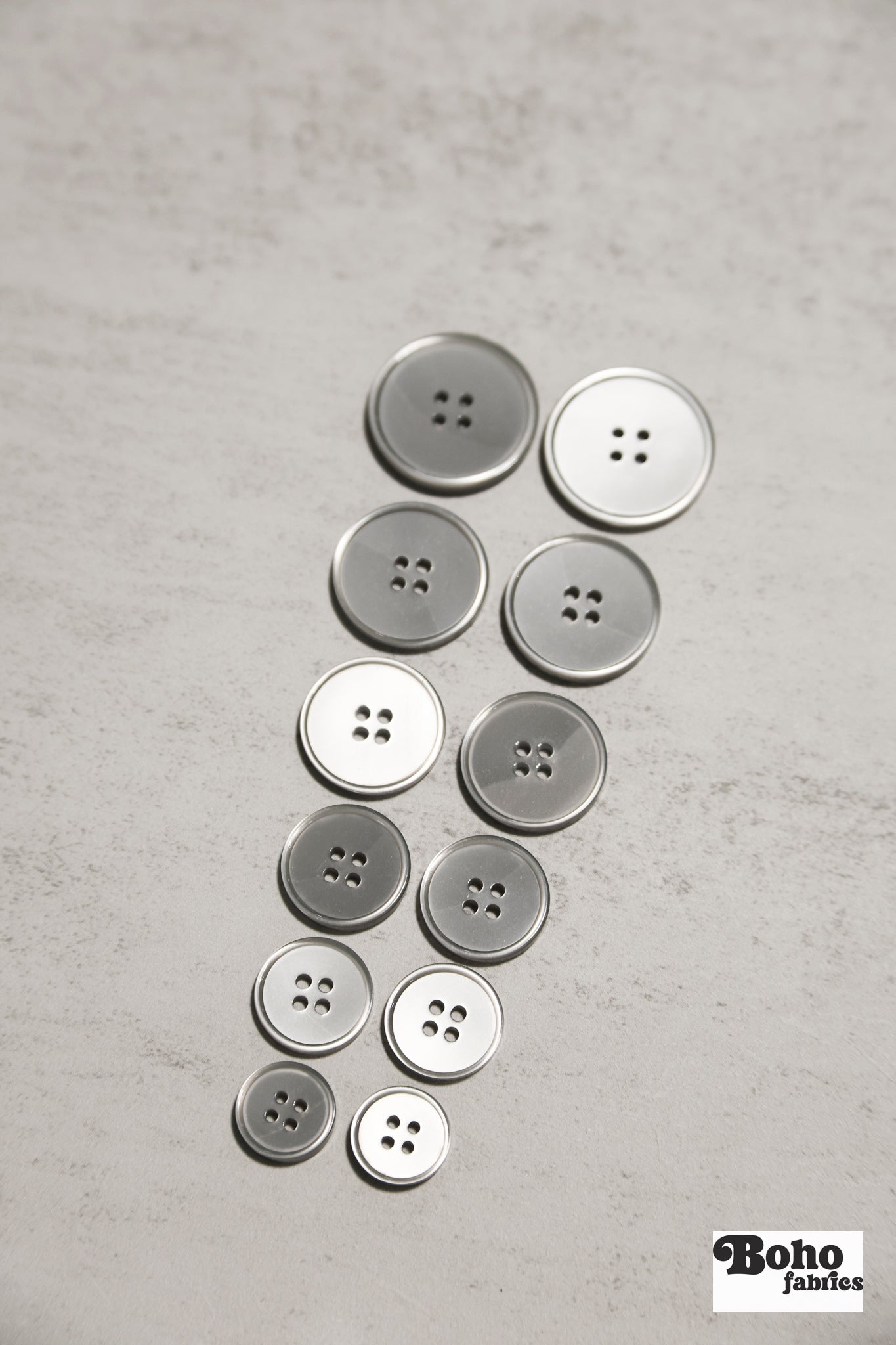 Glossy Silver/Gray Four Hole Plastic Buttons. 24L (15mm/ 5/8"), 28L, (18mm/ 11/16"), 32L (20mm / 13/16"), 36L (23mm, 7/8"), 40L (25mm/ 1"), 44L (28mm/ 1 1/8") - Boho Fabrics - Buttons & Snaps
