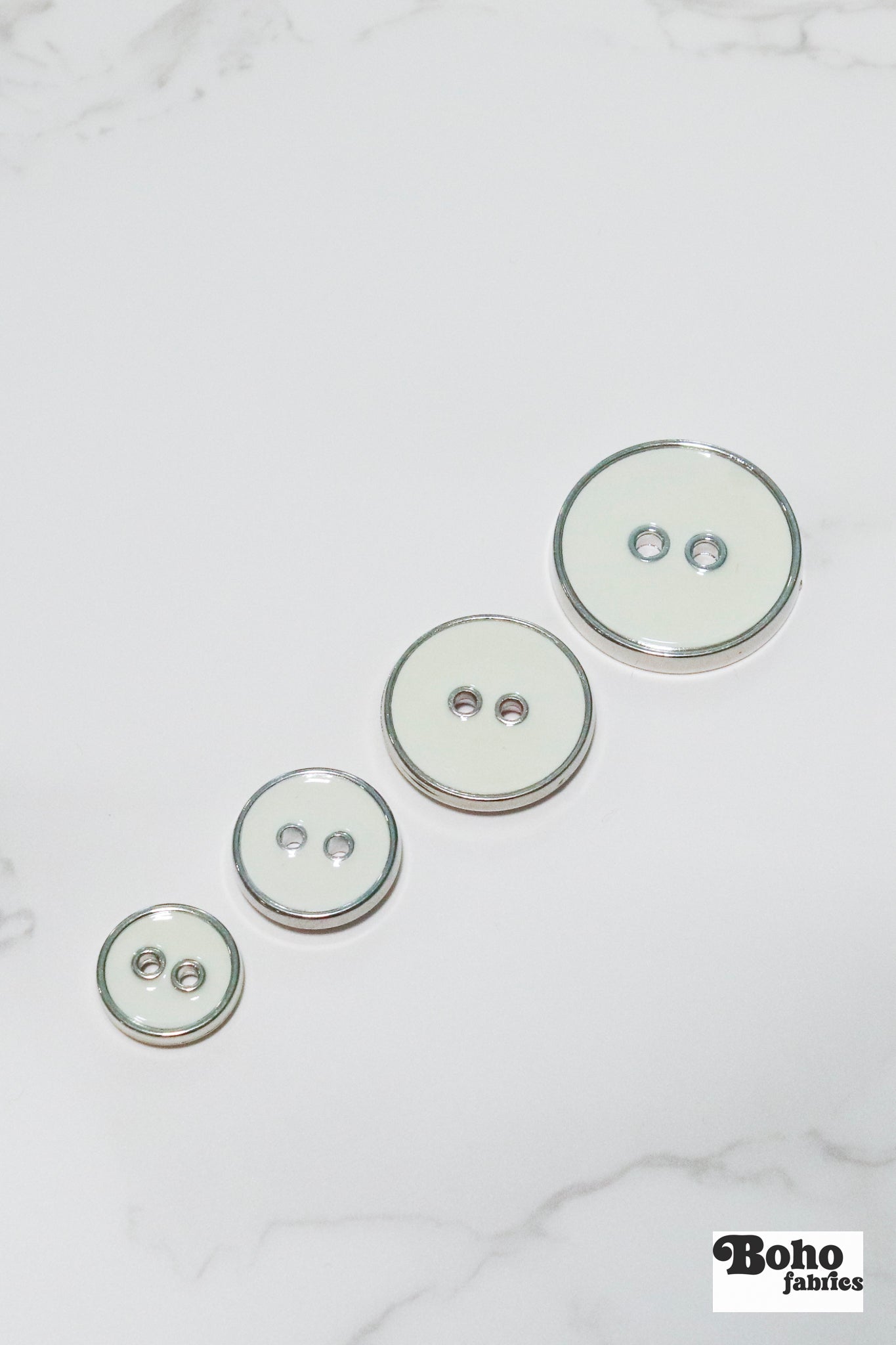 Off White Silver Rimmed Two - hole Buttons. Available in 12.5mm (20L), 15mm (24L), 19mm (30L), 23mm (36L) - Boho Fabrics - Buttons & Snaps